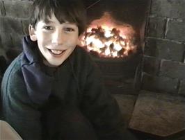 Clyde Fare dries out by the fire at Treyarnon Bay YH
